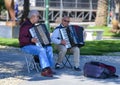 Street artists playing accordions hoping for donations in the Gardens by the Sea, Santa Margherita Ligure, Italy